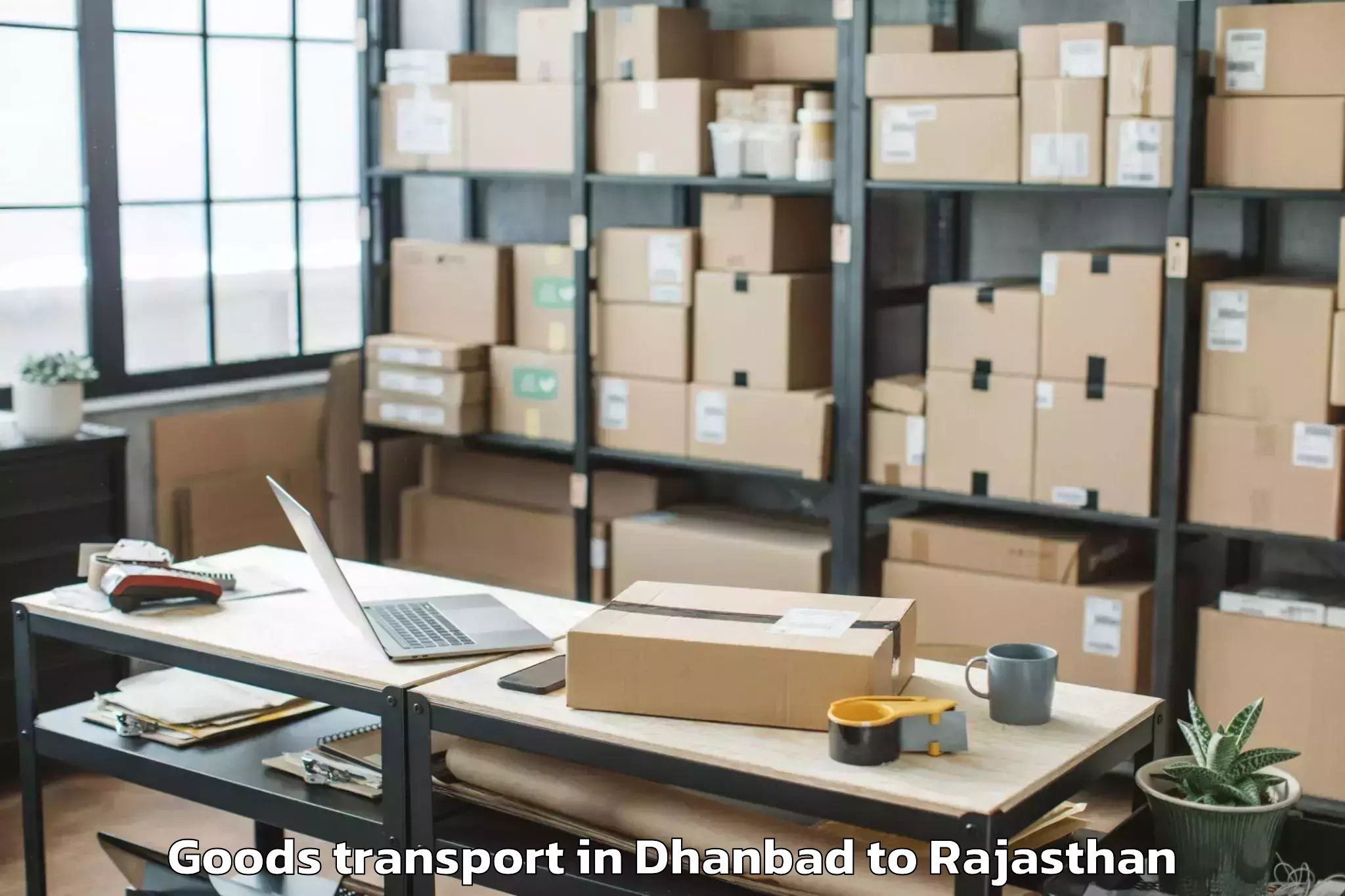 Reliable Dhanbad to Opjs University Churu Goods Transport